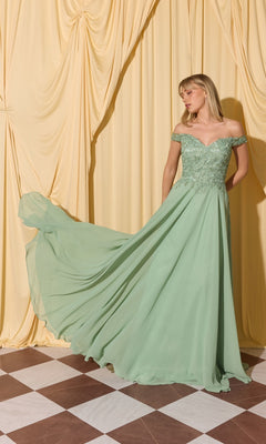 A woman in the Long Prom Dress: Eureka EK211, a light green off-the-shoulder gown with lace applique bodice, stands before cream drapes on a checkered floor.