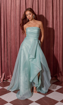 Woman in the Long Prom Dress: Eureka EK216 in Sea Glass stands on a checkered floor before mauve curtains, one leg visible through the flowing a-line skirt.