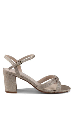 The Elle Champagne Glitter Prom Shoes (Touch Ups 4642) feature a single block heel, ankle strap with buckle, open toe, and crisscross front straps—an elegant low-heel option for stylish prom attire.