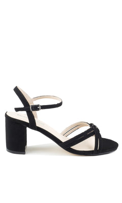 The Elle Black Formal Prom Shoes: Touch Ups 4643 are black suede sandals with a low block heel, open toe, crisscross front straps, and an ankle strap with buckle—ideal for stylish prom attire.