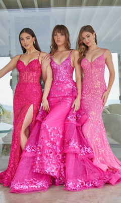 Three women stand side by side wearing bright pink Ellie Wilde evening gowns, including the stunning Ellie Wilde Long Lace Mermaid Prom Dress EW35005 with intricate lace and sequin detailing.