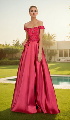 A woman stands on a lawn in front of a pool, wearing the Chicas XR6007 off-the-shoulder long prom dress with a jeweled bodice and floor-length pink skirt.