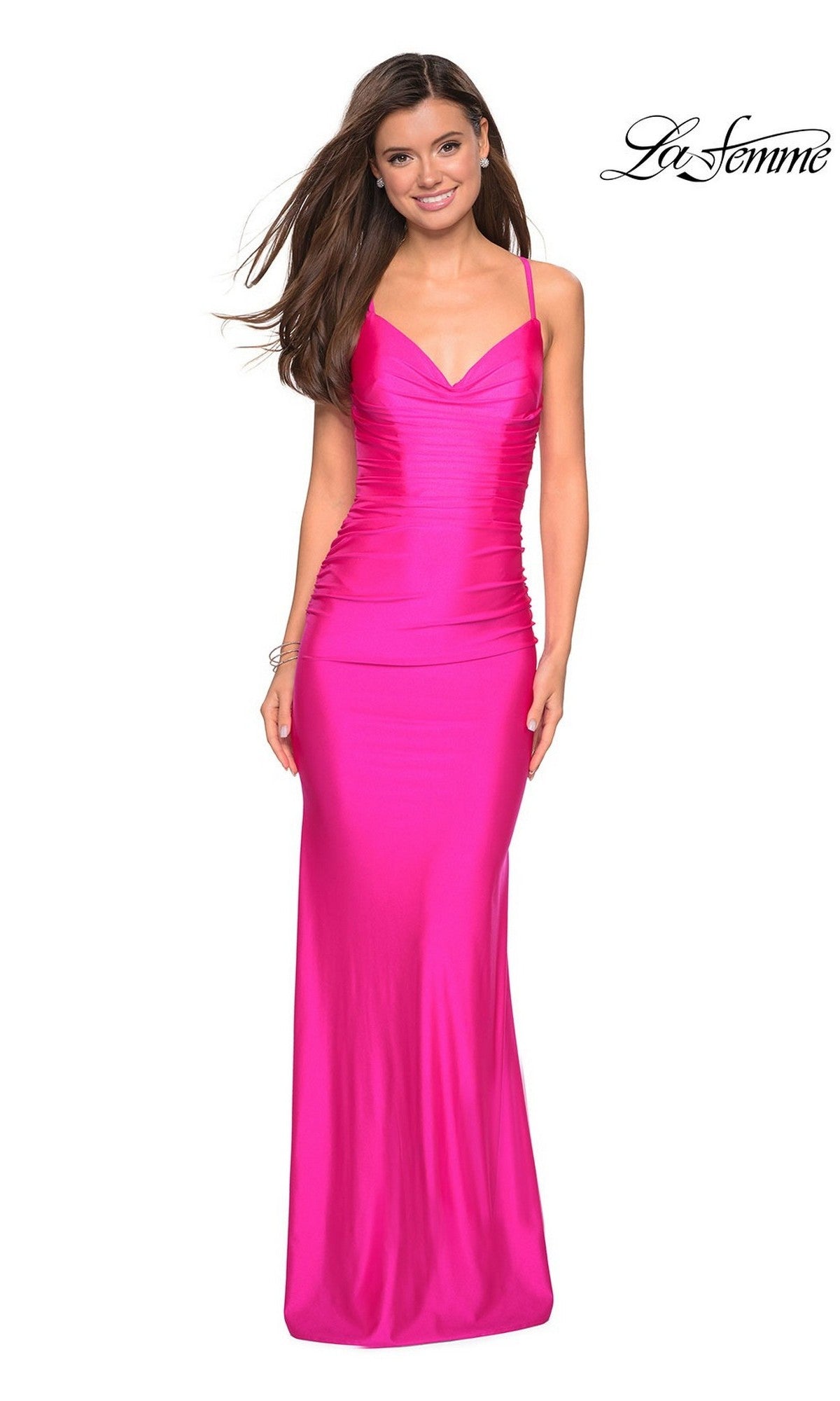 A woman stands and smiles against a white background, wearing the La Femme Cowl-Neck Long Prom Dress 27501—floor-length, bright pink, sleeveless with thin straps. The La Femme logo is displayed in the top right corner.