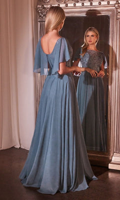 A woman in the Cape-Sleeve Long A-Line Prom Dress: Ladivine HT101 stands before a large ornate mirror, her flowing blue gown and elegant cape sleeves beautifully reflected.