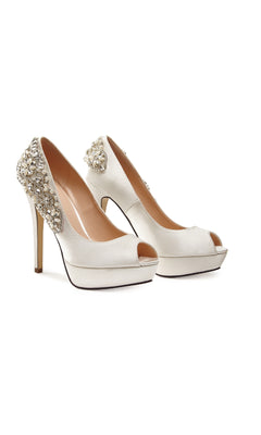 The Indulgence Ivory Satin Prom Shoes by Paradox London (P1710) feature jeweled heels, a chic peep-toe design, and sparkling rhinestone accents for added glamour.