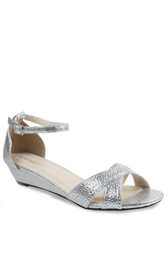 The Iris Silver Wedge Prom Shoes: Touch Ups 4626 feature a silver low wedge, ankle strap, and glittery cross-over front straps—perfect stylish prom shoes—shown on a white background.