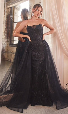 Woman in a Glitter-Print Strapless Long Prom Dress J858 poses in front of a mirror with hands on hips, standing in a room with draped curtains and a large window.