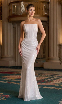 A woman in an off-white, strapless sequined Long Prom Dress—Ladivine J904—stands in a grand, ornate room with columns and a patterned carpet.