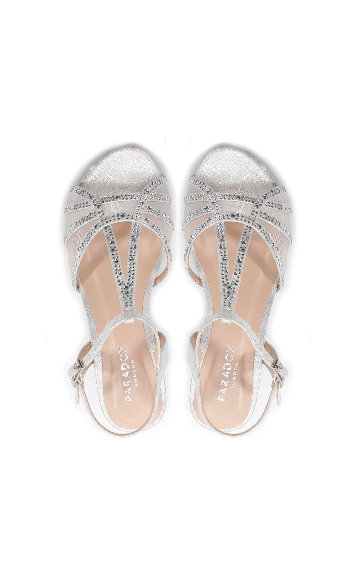 The Jilly Silver Prom Shoes (Paradox London P2001) feature glitter details, beaded and ankle straps, and low wedge heels in a formal design, shown from an overhead view.