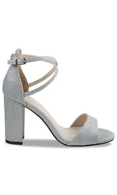 The Jordy Silver Glitter Prom Shoes: Touch Ups 4629 feature high block heels, an open toe, a single front strap, and an adjustable ankle strap—ideal for making a sparkling entrance.