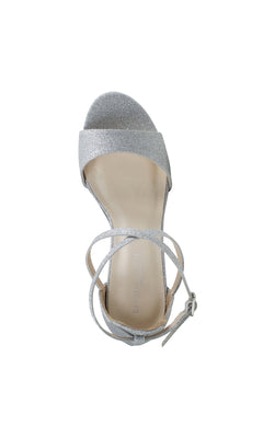 The Jordy Silver Glitter Prom Shoe by Touch Ups 4629 features a high block heel, open toe, ankle strap with buckle, and is shown from above on a white background.