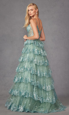 A woman poses against a gray backdrop in the Long Ruffled A-Line Prom Ball Gown (Juliet JT2454K), featuring elegant sleeveless styling, floral sequin details, and tiered ruffles in light teal.