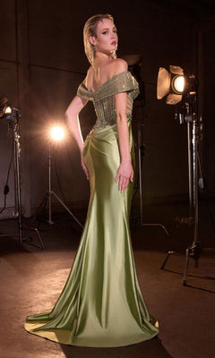 A woman poses elegantly in a photography studio wearing the Ladivine KV1140 Long Prom Dress, featuring a shiny, off-the-shoulder design and a beaded bodice.