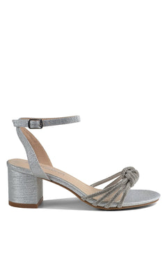 The Libra Silver Glitter Prom Shoes (Touch Ups 4651) feature a silver open-toe design with a low block heel, ankle strap, and knotted multi-strap front—an ideal stylish choice for prom.