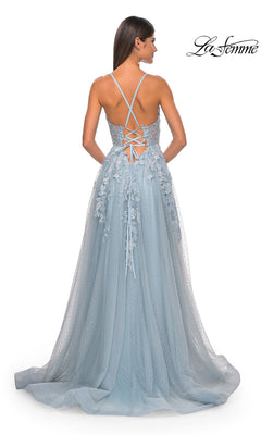 A woman is seen from behind wearing the La Femme Lace-Embroidered Long Prom Dress 32147 in light blue, which features thin shoulder straps, a lace-up back, and embroidered floral lace appliqué details.