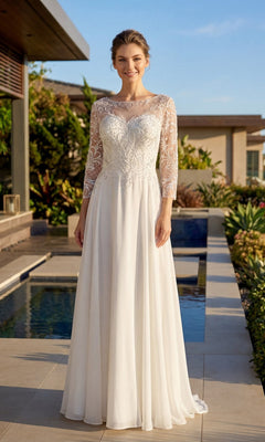 A woman stands outdoors near a pool, surrounded by greenery, wearing the Long Formal Dress: Juliet M11-W—a white wedding gown featuring lace sleeves and an embroidered bodice.