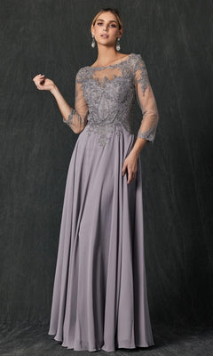A woman wearing the Juliet M12 Long Formal Dress in silver, featuring a floor-length silhouette with sheer lace sleeves and intricate floral lace embroidery on the bodice, stands against a dark textured background.