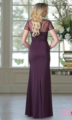 A woman with long, wavy blonde hair wears the Marsoni M350, a floor-length plum formal dress with short sleeves, lace detailing, and a beaded bodice, standing indoors and facing away from the camera.