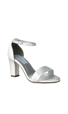 The Maddox White Satin Prom Shoes (Dyeables 58217) feature a low block heel, open toe, ankle strap with buckle—perfect for elegant occasions. Photographed on a plain white background.