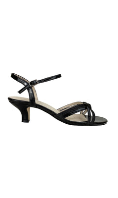 The Melanie Black Glitter Prom Shoes: Touch Ups 305 feature a 1.75-inch heel, open toe, ankle strap, and knot detail on the toe strap, shown against a white background.