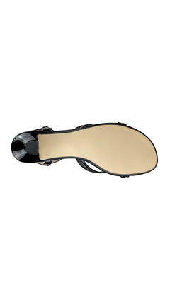 Bottom view of Melanie Black Glitter Prom Shoes: Touch Ups 305, featuring a smooth beige sole and thin ankle strap, against a white background—perfect open-toe sandals for your next special occasion.