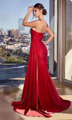A woman stands indoors by large windows overlooking a cityscape, wearing the Side-Sash One-Shoulder Long Prom Dress PT004 in red.