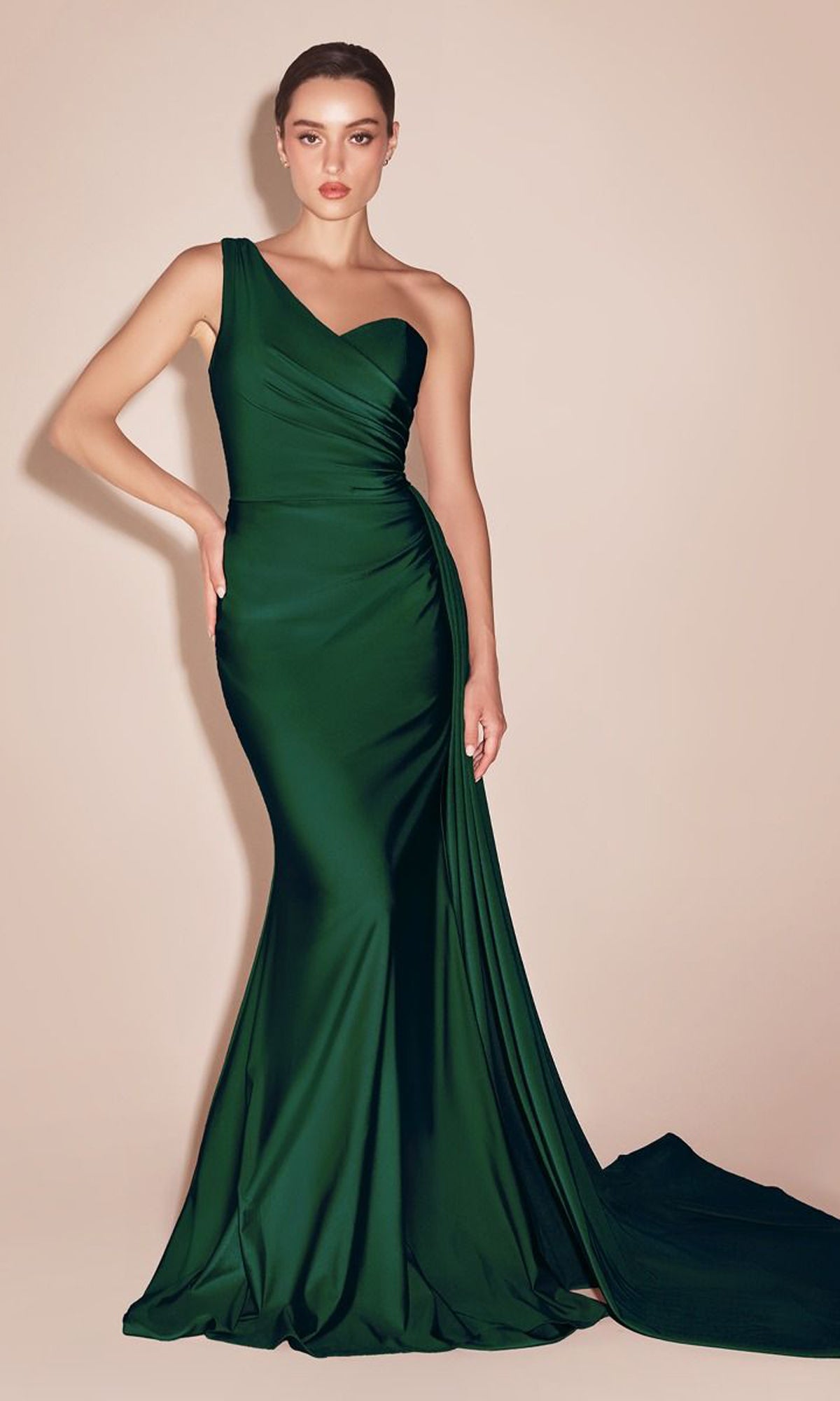 A woman in the Plus-Size Long Sweetheart Prom Dress PT004C—an emerald green, one-shoulder, floor-length gown with a side drape—stands elegantly against a neutral background.