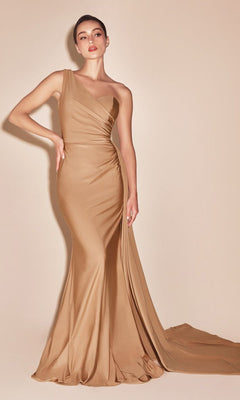 A woman stands against a beige background wearing the Plus-Size Long Sweetheart Prom Dress PT004C, a fitted, floor-length gold evening gown with a one-shoulder design and slight train.