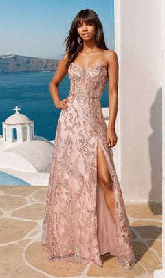 A woman in the Dancing Queen 4402 Long Glitter-Print Prom Dress, featuring thin straps and a thigh-high slit, stands outdoors near white buildings and a blue sea.