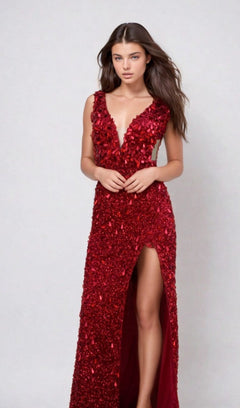 A woman stands against a plain light background wearing the Aleta Long Formal Prom Dress 1204—a sleeveless, deep V-neck red gown with beading, floral embellishments, sheer illusion sides, and a thigh-high slit.