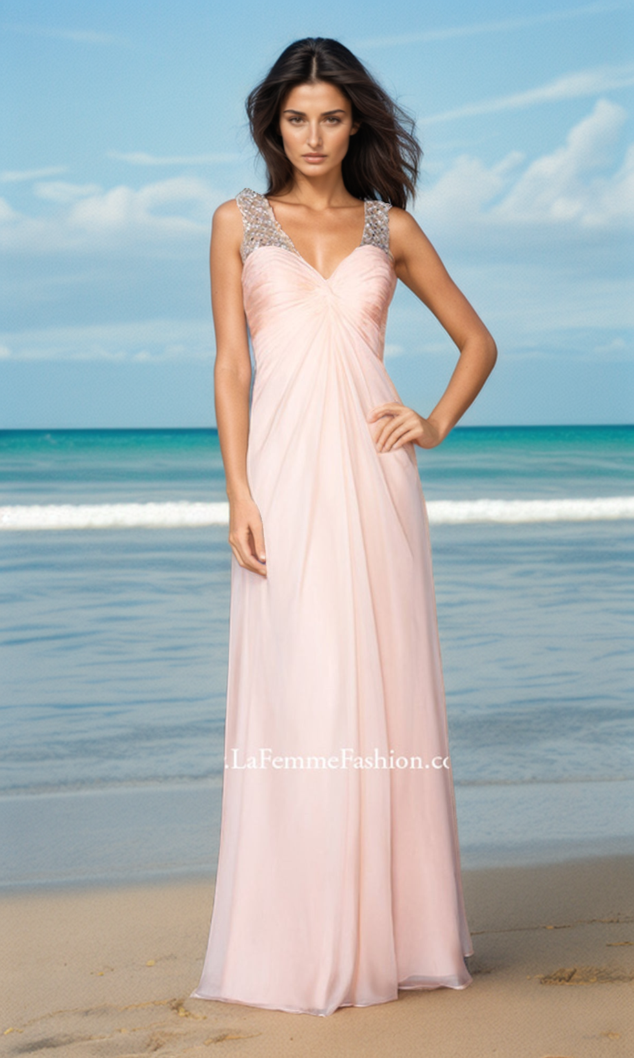 A woman wearing the La Femme Dress 20122, a long pale pink chiffon gown with embellished straps, stands on a sandy beach with the ocean and sky in the background.