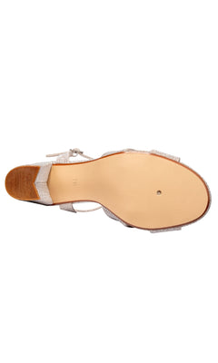 Bottom view of the Riley 2.5" Champagne Prom Shoe by Touch Ups 4657, featuring a light brown sole, low heel, and glittery champagne open-toe upper straps.