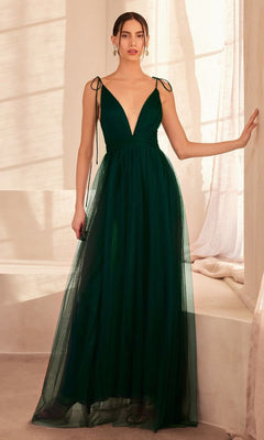 A woman stands indoors in the Amoris SE005 Double-Slit Long V-Neck Prom Dress—a deep green, floor-length A-line gown featuring a plunging neckline and tie shoulder straps.