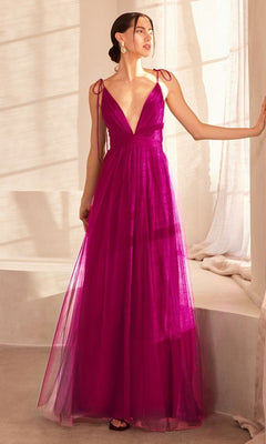 A woman stands indoors wearing the Amoris SE005 Double-Slit Long V-Neck Prom Dress—a sleeveless, floor-length magenta tulle A-line style with thin shoulder ties.