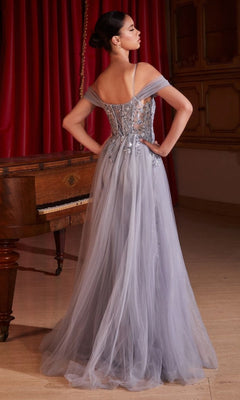 A woman in a light blue Tulle Overskirt Long Formal Dress, Ladivine SF009, stands with her back to the camera in front of a piano and red curtains.