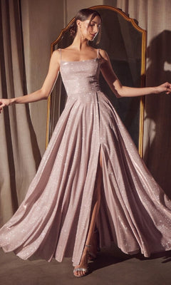 A woman poses in front of a mirror wearing the Classic Long Glitter Prom Dress: Amoris T213, a sparkling light pink A-line formal dress with thin straps and a high slit.