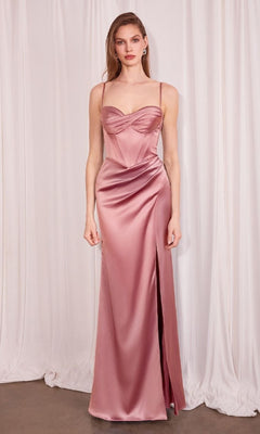 A woman stands in front of white curtains wearing the Long Sweetheart Prom Dress: Amoris T608, a mauve satin evening gown with spaghetti straps, a corset-style bodice, and a thigh-high slit.