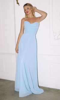 A woman poses indoors against a white wall wearing the Strapless Long Chiffon Prom Dress: CLT703, a light blue, floor-length gown.
