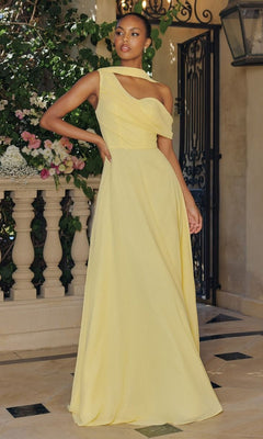 A woman stands on a stone patio in the Amoris T716 Asymmetric Long A-Line Prom Dress, its light yellow hue and one-shoulder design highlighted by flowers and greenery that enhance the elegance of this stunning evening gown.