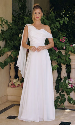 A woman stands in a leafy garden wearing the Asymmetrical Off-White Bridal Gown: Amoris T716W, featuring a long chiffon skirt, draped fabric, and minimal accessories.