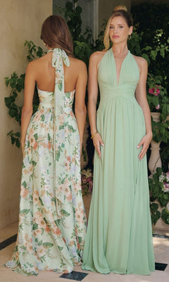 Two women stand before leafy plants—one wears a sage formal open-back dress, the other the Sage Floral Print Long Halter Prom Dress: Amoris T719.
