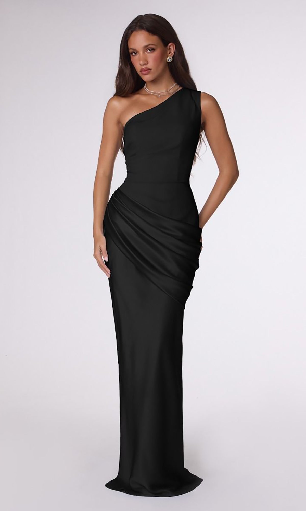 A woman wearing the One-Shoulder Long Prom Dress: Amoris T748, a floor-length, one-shoulder black formal dress with draped detailing at the waist.
