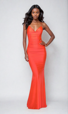 Woman standing in front of a plain background wearing the La Femme Open-Back Long Neon Prom Dress 29020—a fitted, bright red floor-length gown with thin straps and a V-neckline.