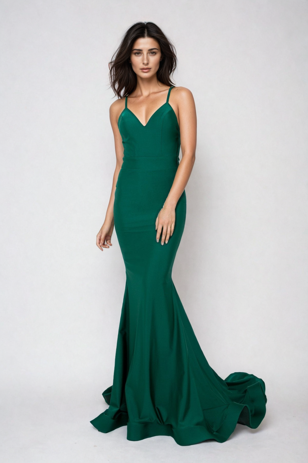 A woman wearing a sleeveless, fitted emerald green Strappy Open-Back Long Prom Dress (Atria 6300H) stands against a plain light backdrop.