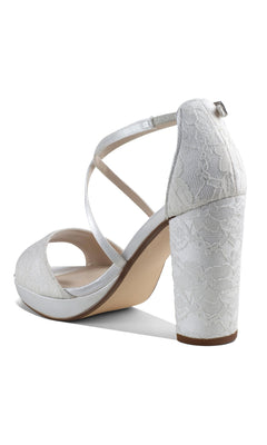 The Violet White Lace Prom Shoes: Dyeables 4611 feature open toes, block heels, crisscross ankle straps, and a lace-textured pattern on the heel and upper—perfect for adding elegance to your look.