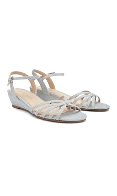The Winslow Silver Prom Shoes: Paradox London P1841 are showcased against a white background, featuring a textured finish, buckle ankle strap, and low strappy wedge design—ideal for prom.