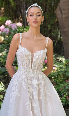 Woman wearing a white lace wedding dress with a garden background