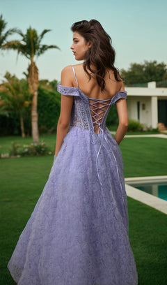 A woman in the Long Prom Dress 11610 by Dave and Johnny stands on a lawn, facing away. Her off-the-shoulder lilac purple gown flows elegantly, with a modern house and palm trees seen in the background.