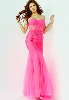 A woman poses against a plain white background wearing the Long Strapless Sweetheart Jovani Prom Dress 5908, a fitted bright pink gown featuring beadwork.