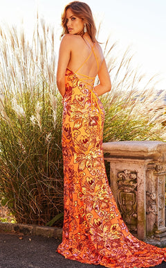 A woman stands outdoors on a stone terrace surrounded by tall grass and sunlight, wearing the Backless Bright Neon V-Neck Jovani Prom Dress 08462; the vibrant colors of the gown catch the light beautifully.